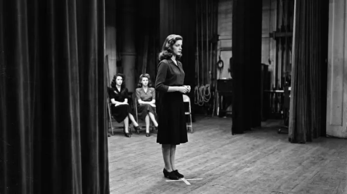 1940s actress practicing a Lauren Bacall-inspired deep side part and poised stance 1940s actress practicing a Lauren Bacall-inspired deep side part and poised stance