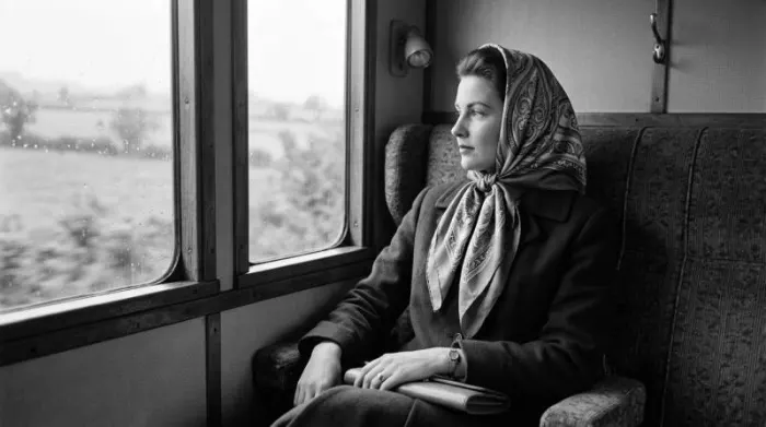 Woman wearing silk headscarf in black and white 1950s setting showing timeless elegance and practical fashion accessory Woman wearing silk headscarf in black and white 1950s setting showing timeless elegance and practical fashion accessory