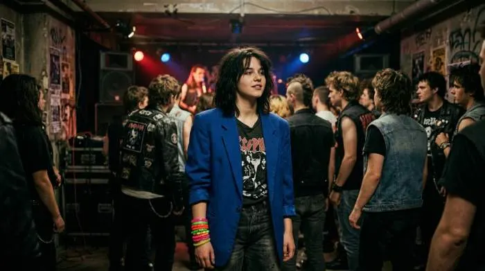 Colorful jelly bracelets stacked on a wrist, symbolizing 1980s punk rebellion style