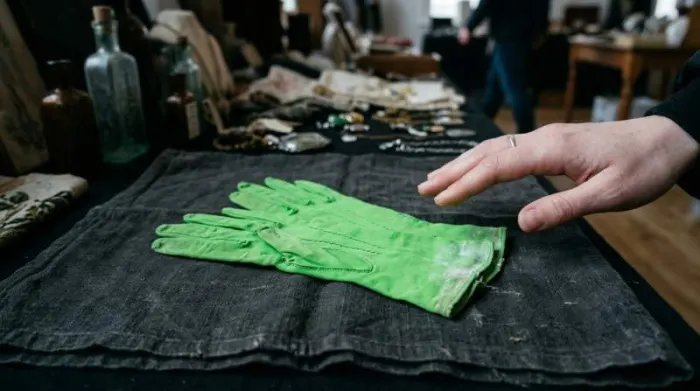Close-up of 1860s green gloves showing toxic arsenic dye that flaked as poisonous dust