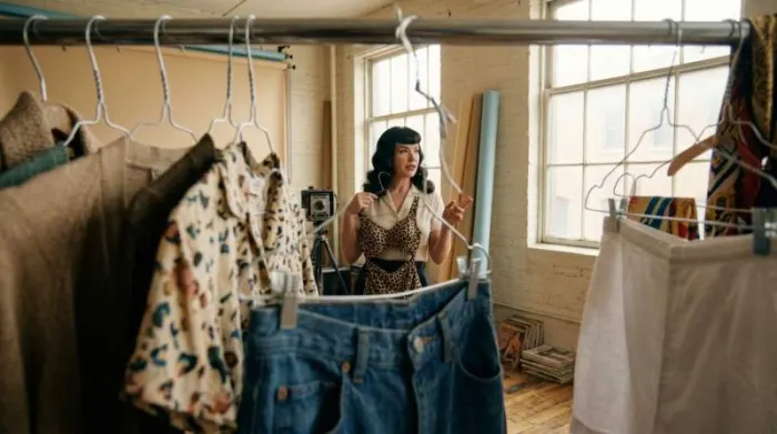 Bettie Page-inspired model choosing affordable clothing for a 1950s pin-up shoot Bettie Page-inspired model choosing affordable clothing for a 1950s pin-up shoot