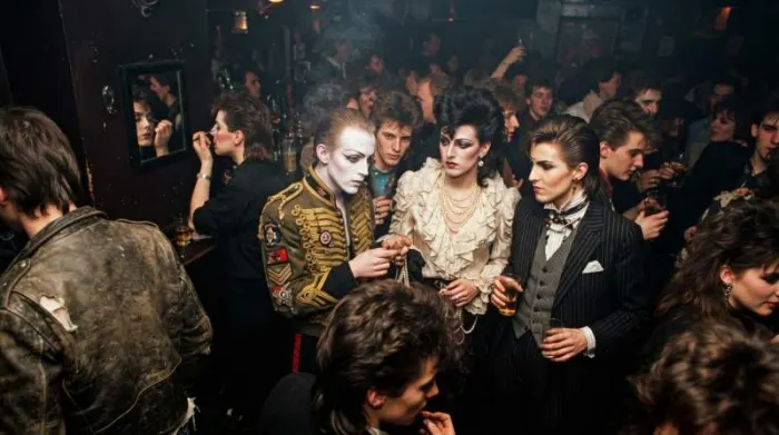 Creatively dressed New Romantics transform the Blitz club into a self-invented world where the audience itself becomes the spectacle.