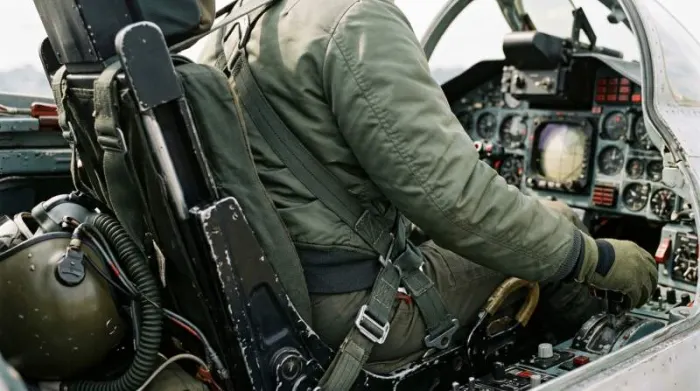 Pilot seated in ejection seat wearing cropped MA-1 bomber jacket Pilot seated in ejection seat wearing cropped MA-1 bomber jacket