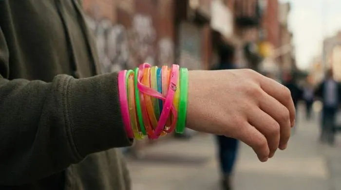 Close-up stack of colorful neon jelly bracelets, symbol of the 1990s sex bracelet panic.