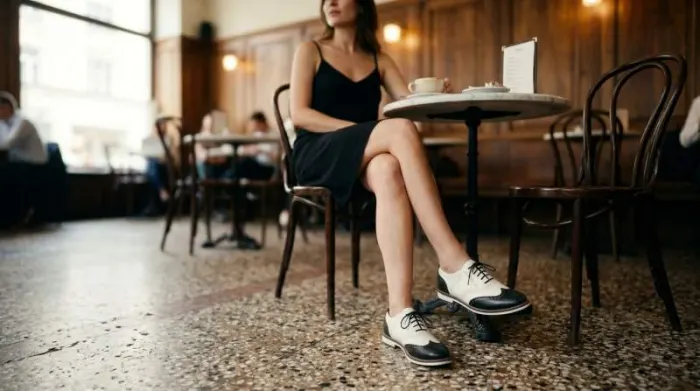 Saddle shoes paired with minimalist black slip dress styling Saddle shoes paired with minimalist black slip dress styling