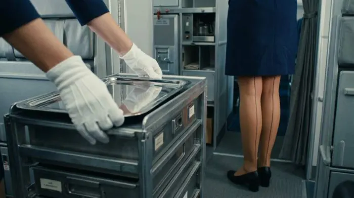 Close-up of white gloves and seamed stockings showing strict grooming discipline in 1960s flight attendant uniform Close-up of white gloves and seamed stockings showing strict grooming discipline in 1960s flight attendant uniform