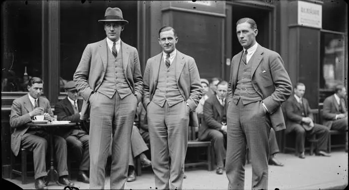 Man in a classic trench coat from the 1920s, embodying functional elegance and clean lines