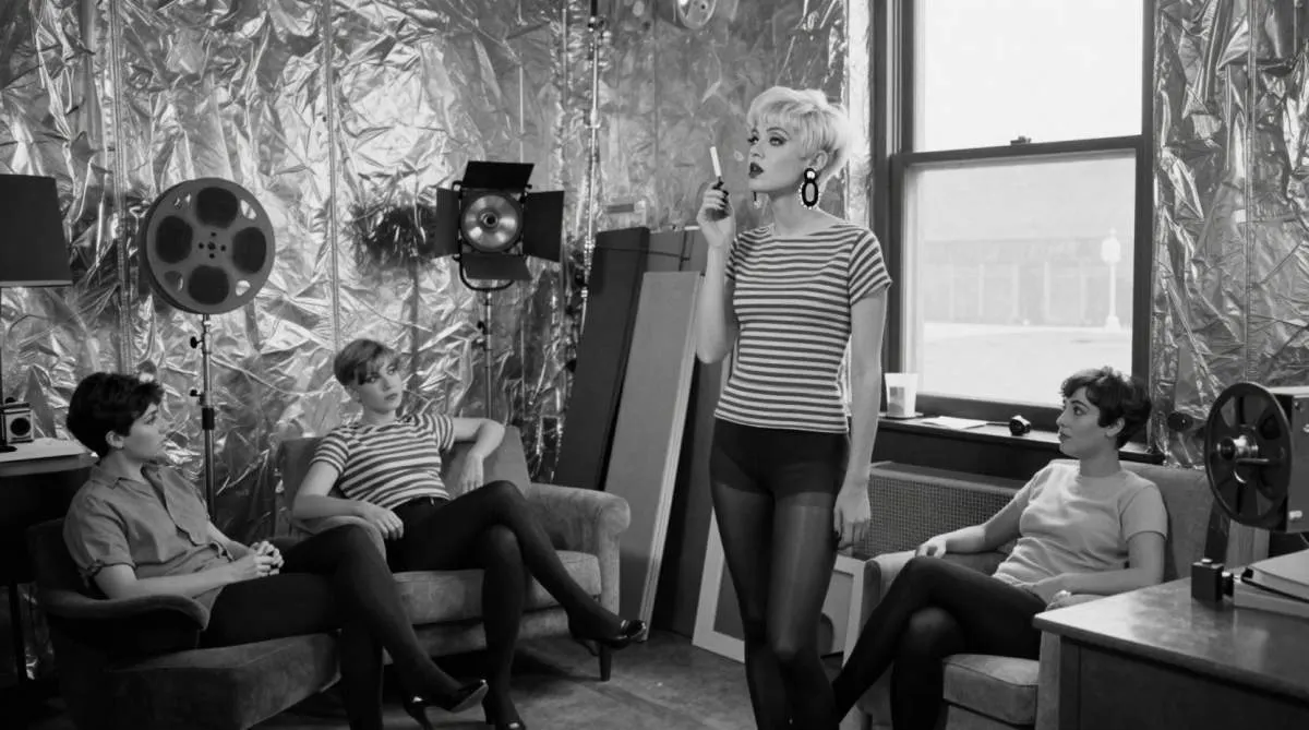 1960s fashion muse inspired by Edie Sedgwick wearing bold eye makeup and mod style in an artist loft