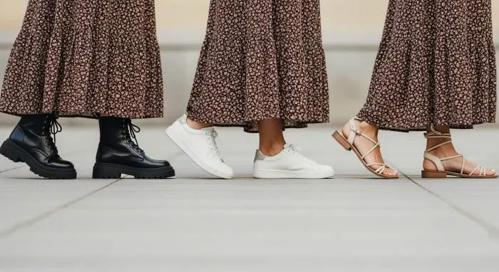 Boho dress paired with combat boots, sneakers, and strappy sandals for modern styling