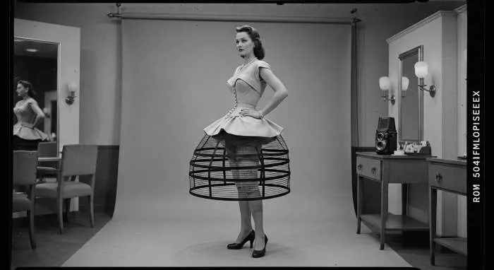 Dior New Look dress with cinched waist and full skirt, symbolizing 1950s femininity