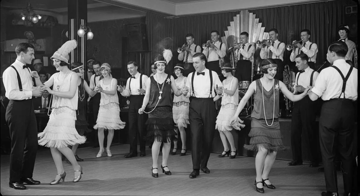 Crowded 1920s jazz club filled with flappers dancing during the roaring twenties era